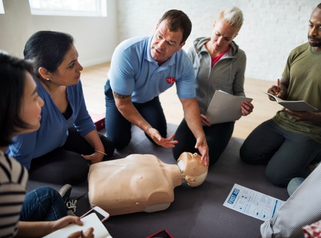 instructor teaching first aid on a vocational first aid course in the uk
